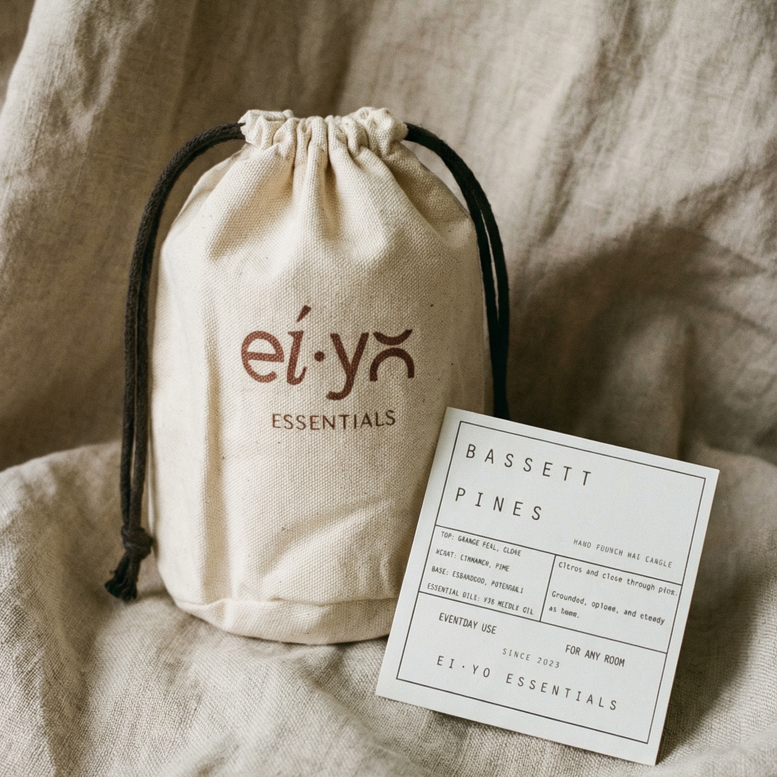 Drawstring bag with 'ei-yo' branding on a textured beige fabric background